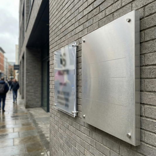 Acrylic and metal signs installed on a UK commercial building for comparison.