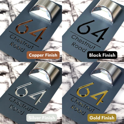 The four lettering finishes side by side: copper, gloss black, silver and gold on a matt grey solar LED house sign