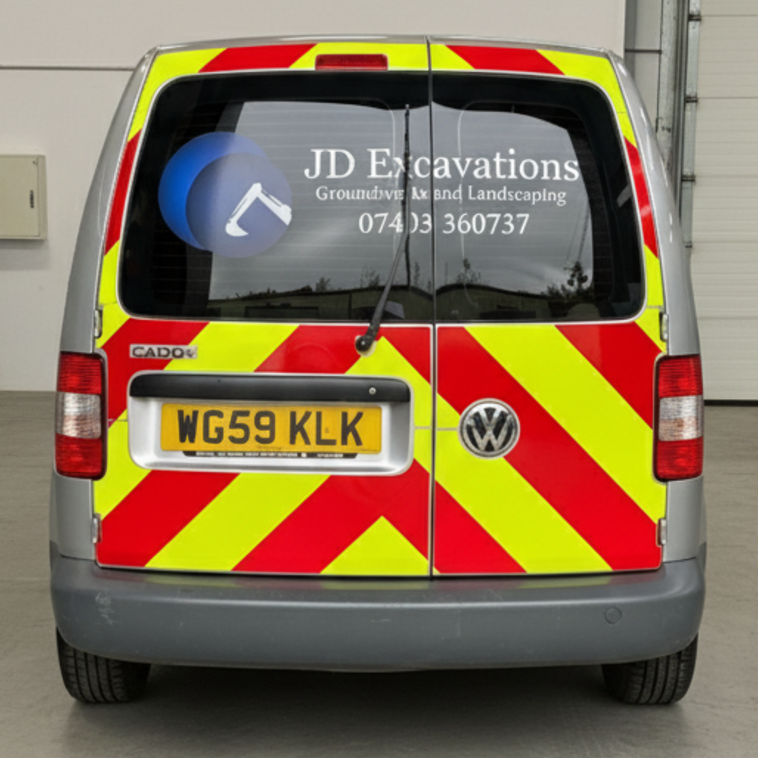 Silver VW Caddy with JD Excavations & chapter 8 chevron graphics installed in Dartmouth