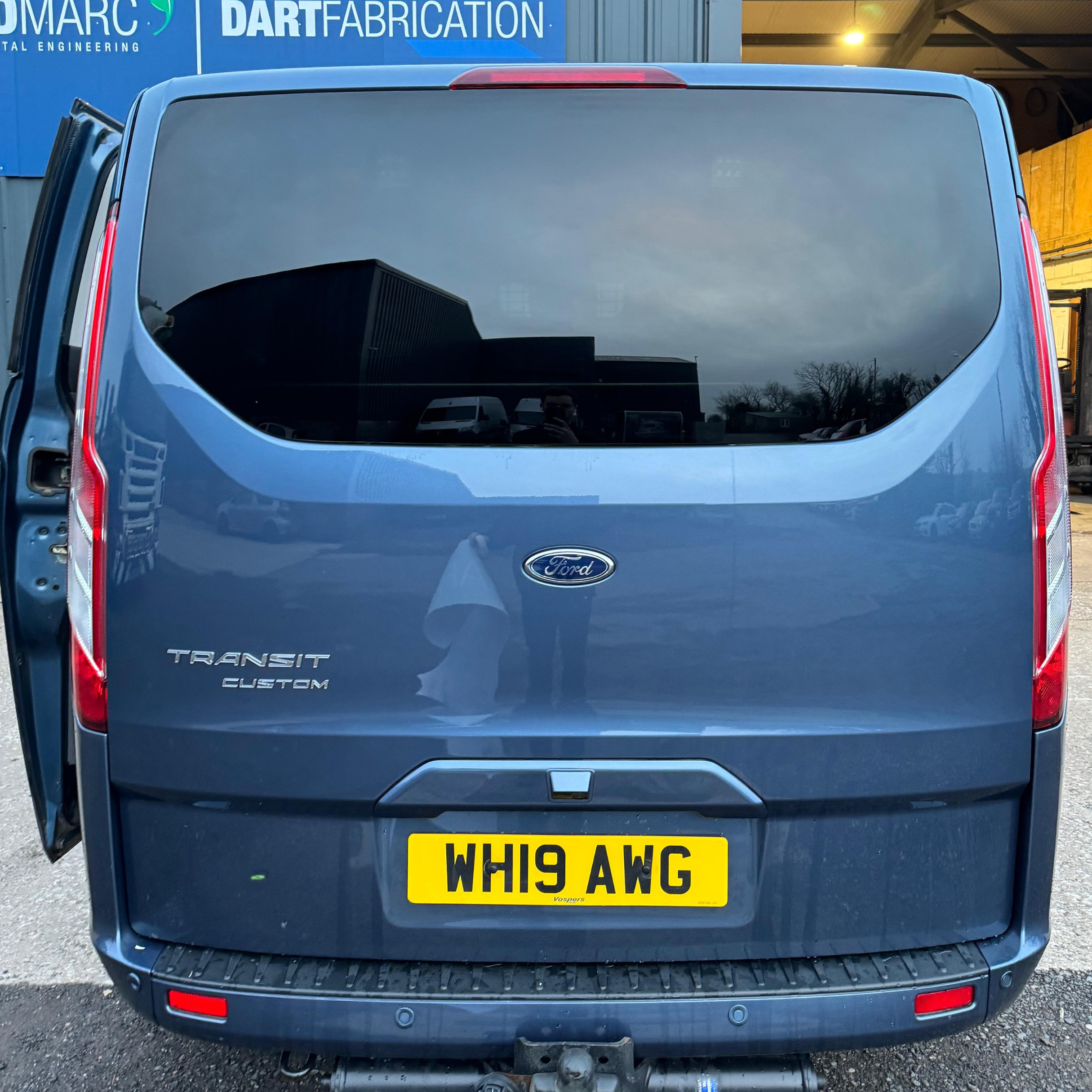 Blue Ford Transit Custom Van before logo window graphics were applied.